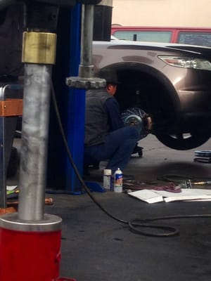 Mechanic servicing a vehicle brake system
